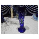 The image displays a collection of various cobalt blue glass items,