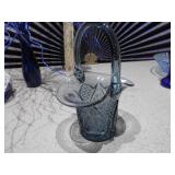 The image displays a collection of various cobalt blue glass items,