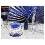 The image displays a collection of various cobalt blue glass items,