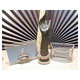 A dark, hand-shaped sculpture