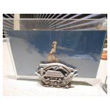 A dark, hand-shaped sculpture