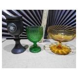 The image displays a collection of vintage pressed glass goblets and a compote dish.