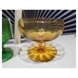 The image displays a collection of vintage pressed glass goblets and a compote dish.