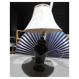 This is a black ceramic ginger jar table lamp