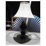 This is a black ceramic ginger jar table lamp