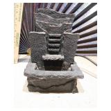 a small tabletop rock water fountain