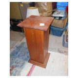 This is a wood pedestal or plant stand