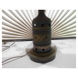 This is an antique wooden wagon wheel hub table lamp