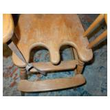 This is a vintage or antique wooden high chair,