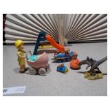 This image features a collection of various vintage and small toy figures