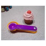 This image features a collection of assorted small plastic toys