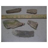 The image displays several pieces of fossilized wood or geological specimens