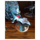 Middle Shelf of Bird Figurines, Bookends, Candy Dish and Suncatcher