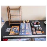 World Travel Collectibles Lot Including Iraqi Coins, Foreign Currency, Spoons, Figurines, and Wooden Display Rack