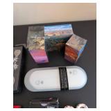 World Travel Collectibles Lot Including Iraqi Coins, Foreign Currency, Spoons, Figurines, and Wooden Display Rack