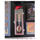 World Travel Collectibles Lot Including Iraqi Coins, Foreign Currency, Spoons, Figurines, and Wooden Display Rack