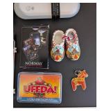 World Travel Collectibles Lot Including Iraqi Coins, Foreign Currency, Spoons, Figurines, and Wooden Display Rack