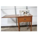 vintage Sears Kenmore sewing machine in cabinet