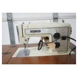 vintage Sears Kenmore sewing machine in cabinet