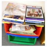 Rm 114B - 3 piles of books and a 3 shelf organizer with crayons