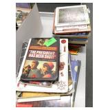 Rm 114B - 3 piles of books and a 3 shelf organizer with crayons