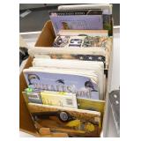 Rm 114B - 3 piles of books and a 3 shelf organizer with crayons