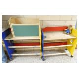 by Rm 110 - 2 portable storage units, a toy box, 3 chairs and a desk