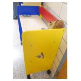 by Rm 110 - 2 portable storage units, a toy box, 3 chairs and a desk