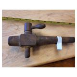 This is an antique wooden barrel spigot or tap. 