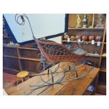 Vintage wicker and wrought iron decorative sleigh, often used as Christmas or holiday home decor