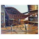 Vintage wicker and wrought iron decorative sleigh, often used as Christmas or holiday home decor