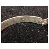 Sterling silver hinged bangle bracelet with a starburst and wave etched design.