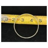 Sterling silver hinged bangle bracelet with a starburst and wave etched design.