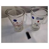 Vintage Budweiser and Michelob glass beer pitchers featuring classic breweriana branding.