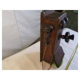 Antique Western Electric oak cased wall-mounted crank telephone, commonly used in the early 20th century