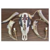 This item is a decorative collectible hand-painted cow skull adorned with Native American-inspired artwork and associated horn accessories.