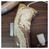 This item is a decorative collectible hand-painted cow skull adorned with Native American-inspired artwork and associated horn accessories.