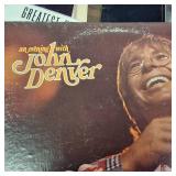 Large collection of vintage music vinyl records featuring artists like Laura Branigan and The Ink Spots