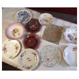 Collection of vintage porcelain and glass dishes, featuring various floral patterns, gilded rims, and crystal designs.