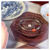 Collection of vintage porcelain and glass dishes, featuring various floral patterns, gilded rims, and crystal designs.