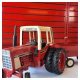 Vintage Ertl 1/16 scale International Harvester 1586 farm tractor toy plus two vintage tin hay wagons