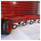 Vintage Ertl 1/16 scale International Harvester 1586 farm tractor toy plus two vintage tin hay wagons