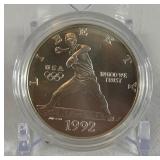 1992 D-Olympic Baseball Commemorative Uncirculated Silver Dollar - just the coin in a protective plastic case, one appears to have slight fire damage