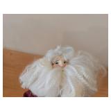 Santa Claus Sitting on a Wicker Chair Figurine by Band Creations