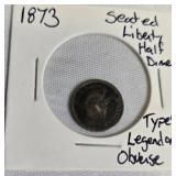 1873 Seated Liberty Half Dime  Type 4, featuring a legend on the obverse side.