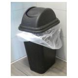 4 garbage cans and a wet floor sign