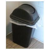 4 garbage cans and a wet floor sign