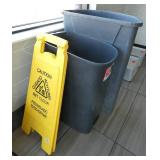 4 garbage cans and a wet floor sign