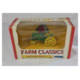 Diecast John Deere Model A tractor features a green body with yellow spoked wheels and detailed engine components. Packaged in the original window box labeled Farm Classics by ERTL. Classic farm toy r