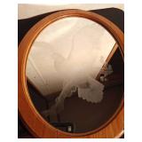 wood framed oval mirror with eagle etched on it
